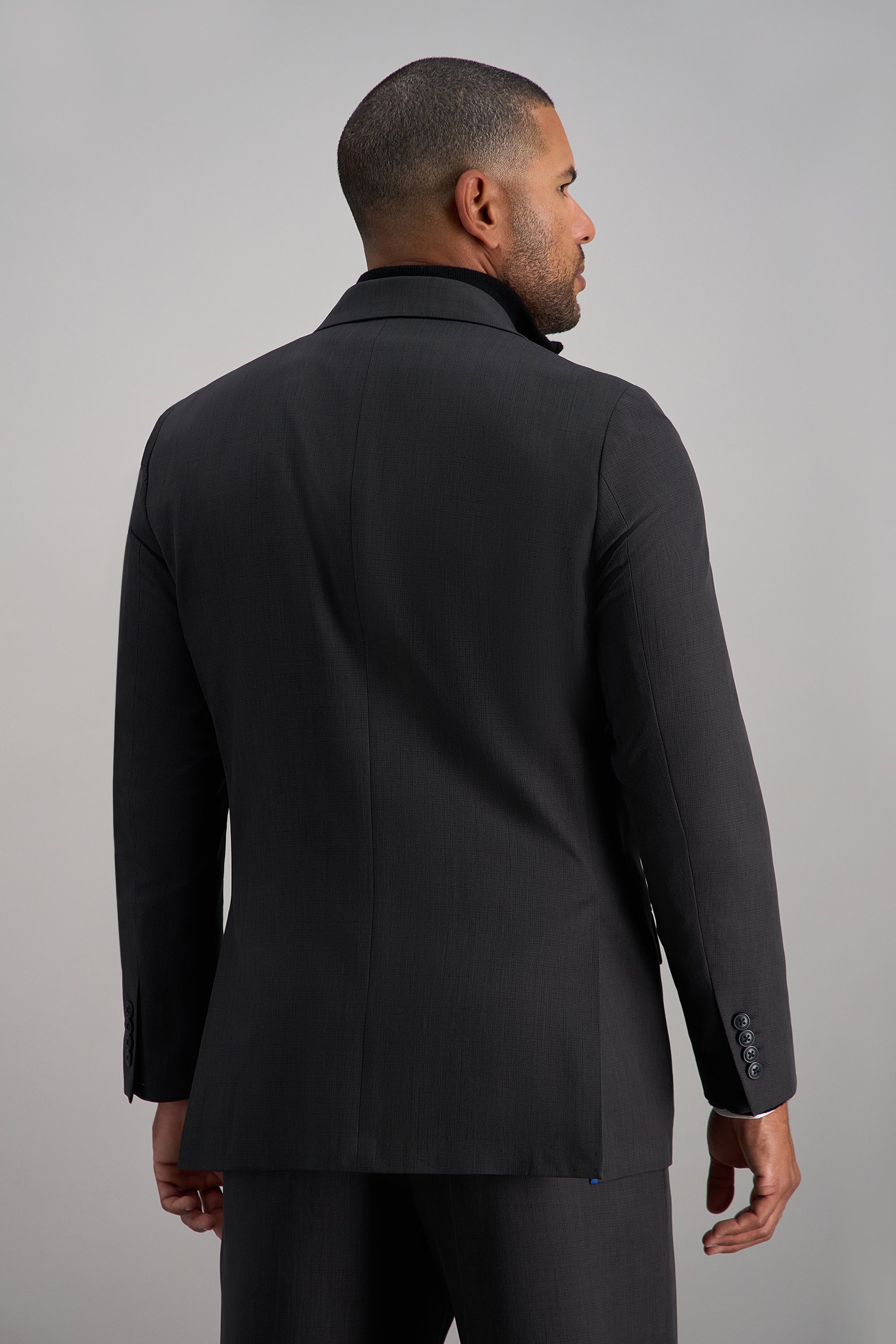Haggar Smart Wash Repreve suit jacket displayed on a hanger, featuring a tailored fit and classic design in a neutral color.#color_dark grey