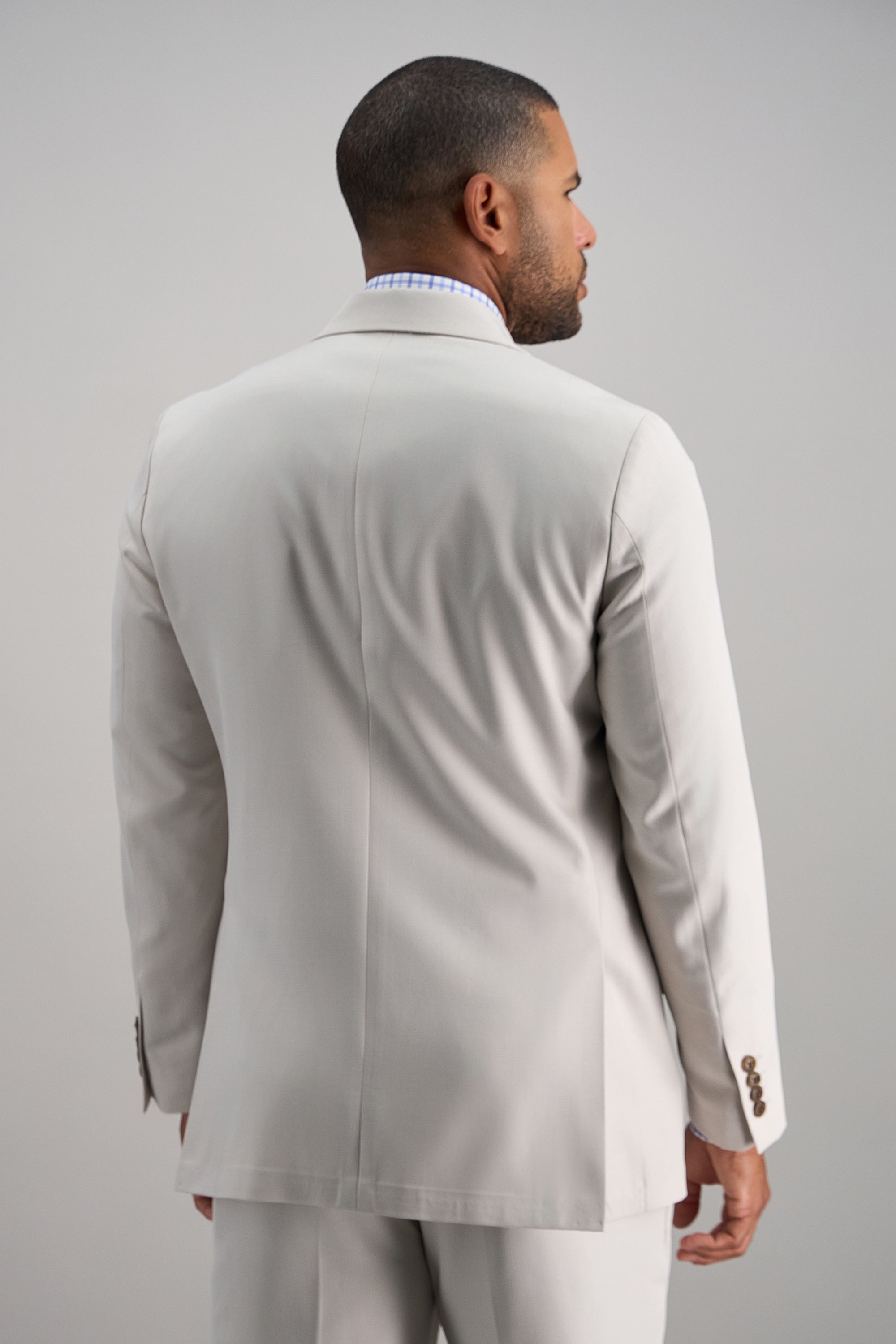 Haggar Smart Wash Repreve suit jacket in navy, tailored fit with notch lapels, displayed on a hanger.#color_string