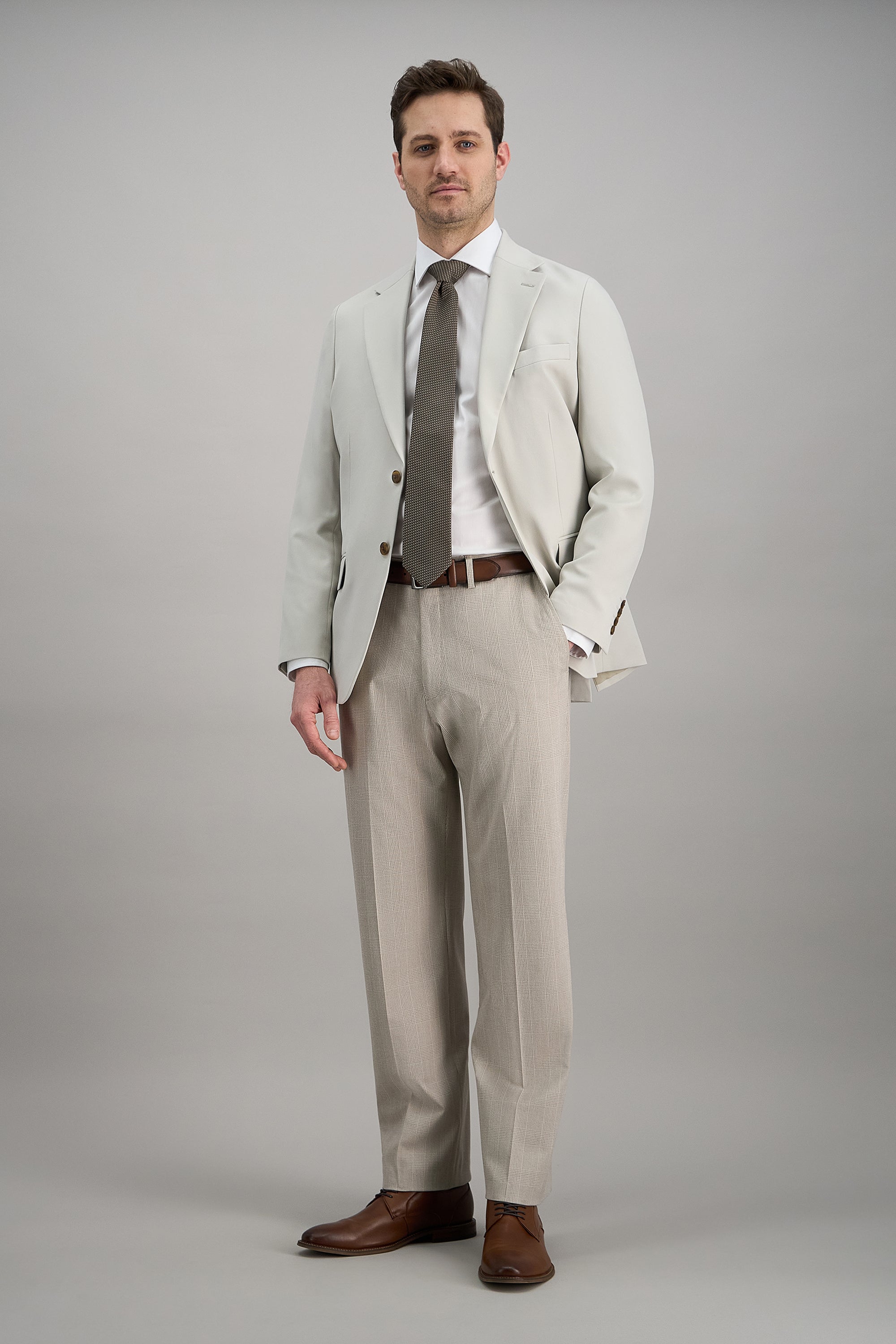 Haggar.com J.M. Haggar™ premium stretch Glen plaid dress pants with tailored fit and classic pattern, shown on a model.#color_stone
